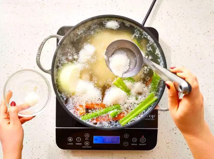 Ingredients cooking in a pot, simmering uncovered