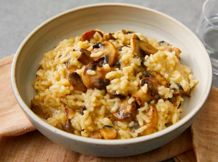 A high-angle shot of a bowl filled with mushroom risotto.