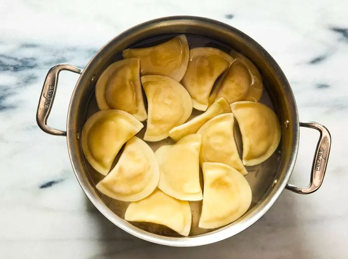 pierogi floating to the surface of the boiling water