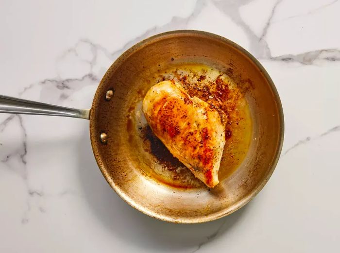 A pan with a perfectly browned chicken breast