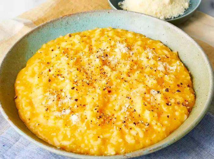 A close-up shot of a large bowl filled with creamy butternut squash risotto.