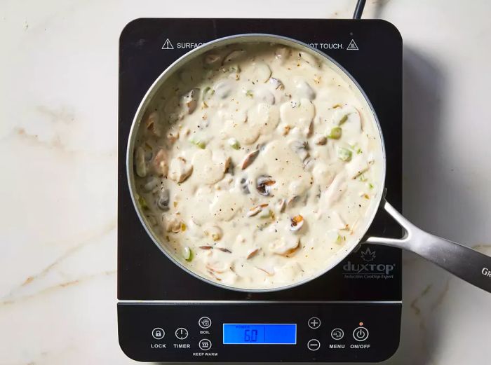 Turkey, soup, broth, and sour cream added to the skillet