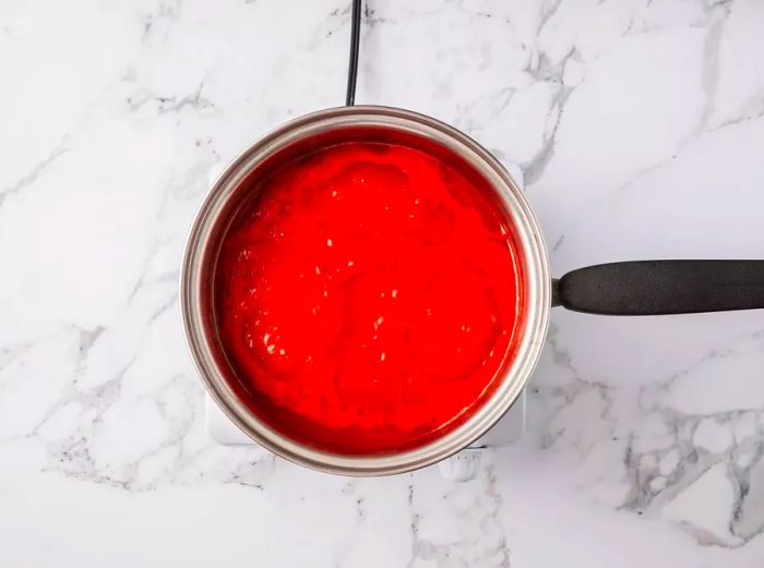 Tomato sauce simmering in a pot.