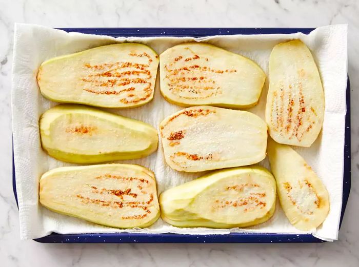 Top view of eggplant slices resting on paper towels.