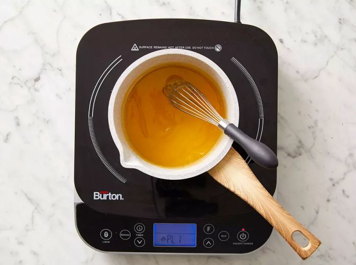 Top view of butter melting in a saucepan.