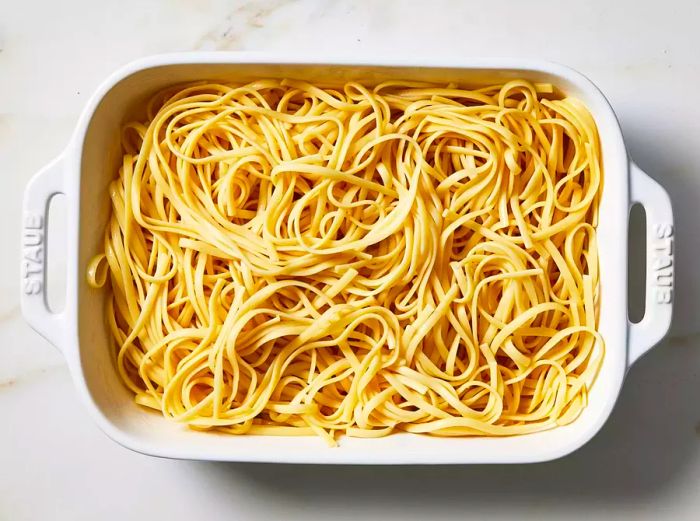 Cooked pasta transferred into the prepared baking dish