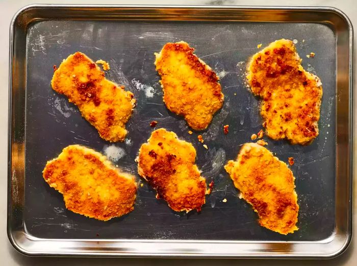 The pork chops after frying and baking to perfection.