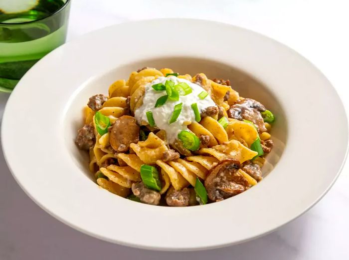 Ground beef stroganoff served in a white bowl.