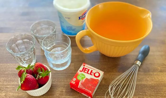 Essential ingredients and tools for making Jell-O yogurt cups