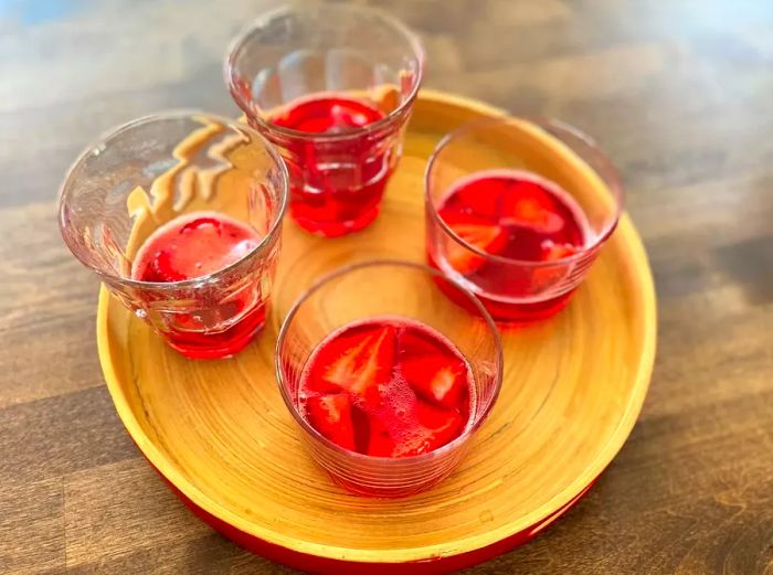 Glasses filled with sliced strawberries and Jell-O