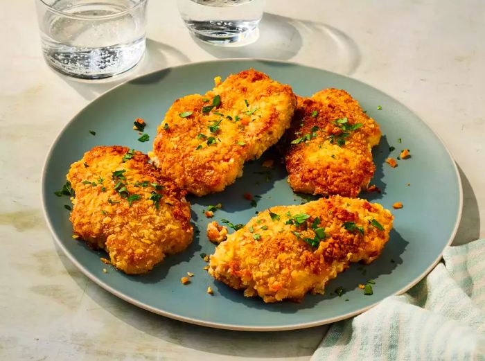 A close-up of a plate filled with crispy, golden-brown pork chops.