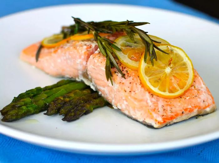 Lemon-infused salmon served on a bed of fresh asparagus.