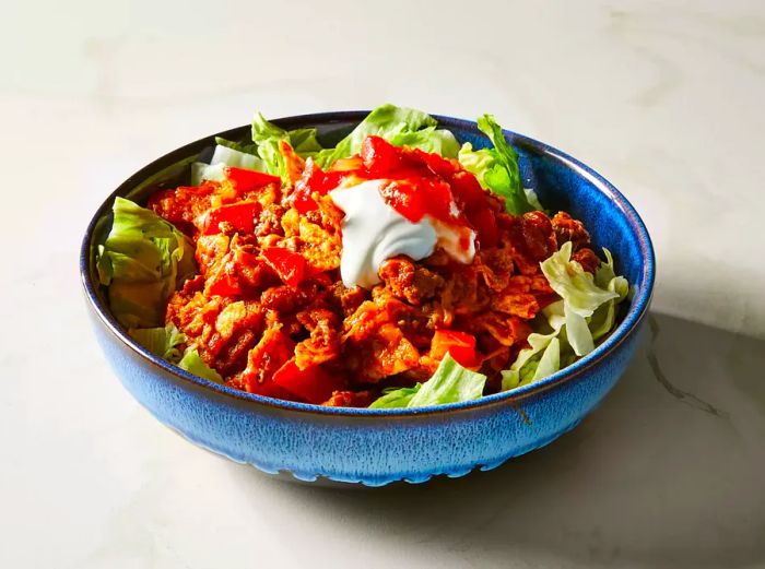 A close-up shot of a bowl filled with taco salad.