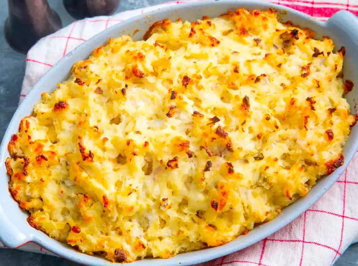 A high-angle view into a casserole dish filled with Steakhouse Potatoes Romanoff.