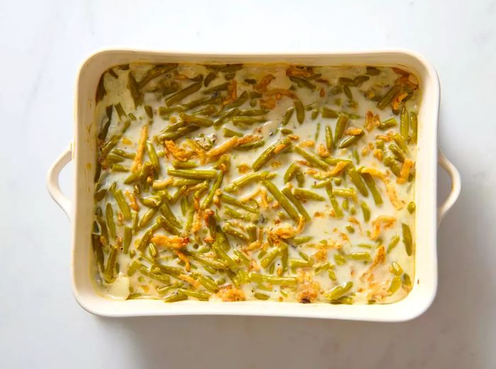 A baking dish filled with creamy green beans, freshly baked to perfection.