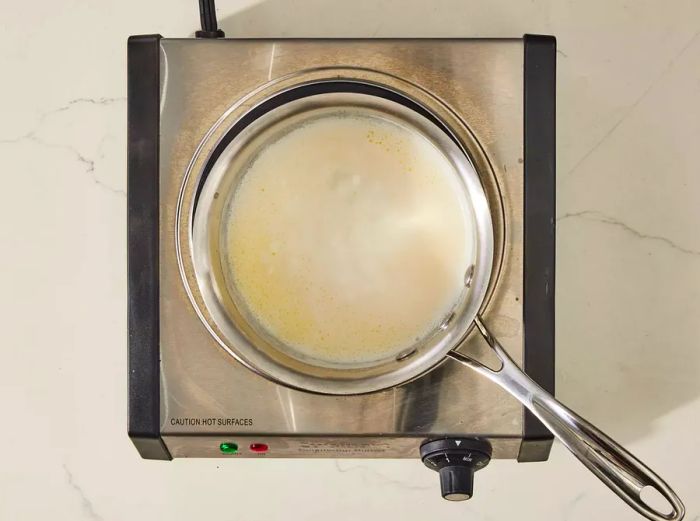 A small saucepan with milk and melted butter