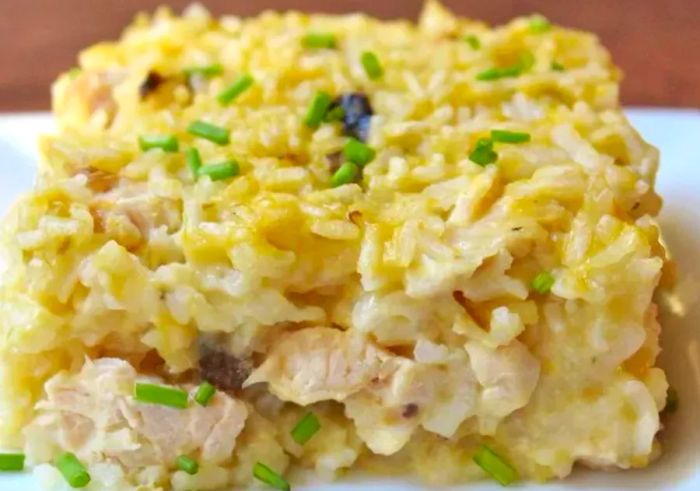 A close-up view of a cheese-topped chicken casserole serving