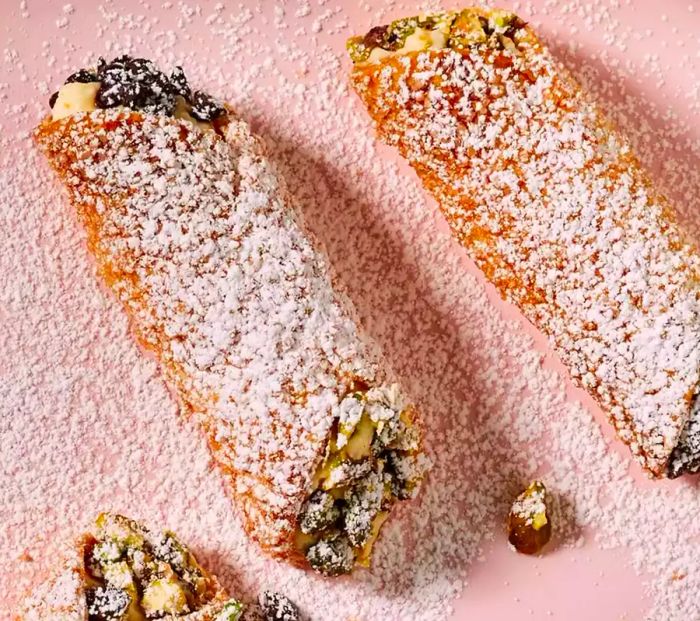 Air fryer cannolis, lightly dusted with powdered sugar, offer a crispy, golden treat that's just as delightful as traditional fried versions.