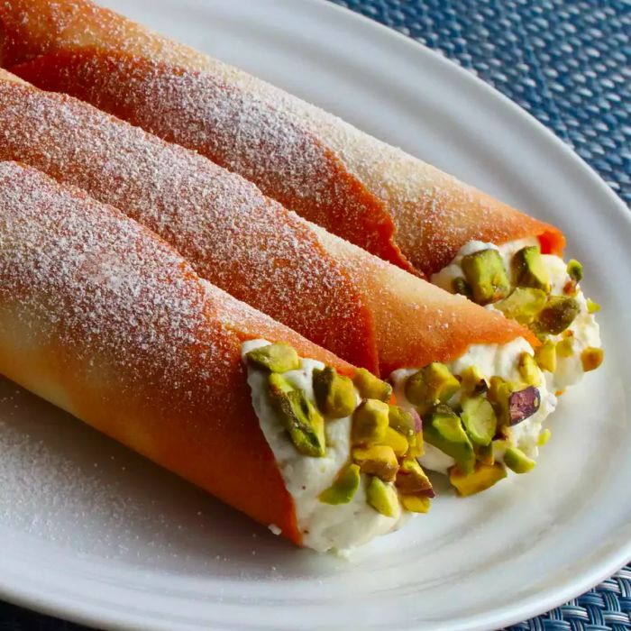 A cannoli filled with ricotta and made using wafer cookies.