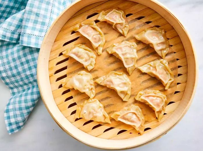 Pork dumplings arranged in a steamer, ready to cook.