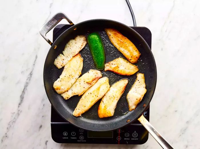Fish fillets fried until golden-brown and easily flaked with a fork.