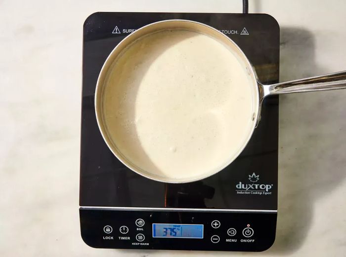 White sauce simmering in a saucepan on the stove