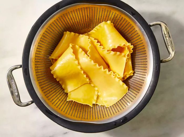 Lasagna noodles draining in a colander