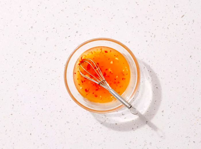 A small bowl filled with spring roll dipping sauce.