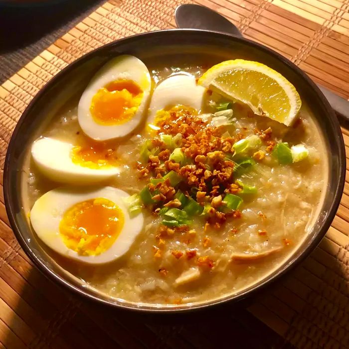 A top view of a warm bowl of chicken arroz caldo porridge
