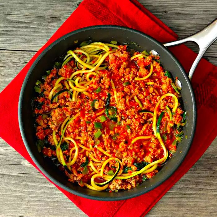 Turkey and zoodles (zucchini noodles) sautéed together in a skillet