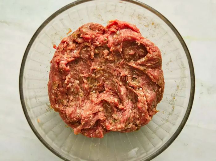 A top-down view of the ground lamb mixture in a bowl.