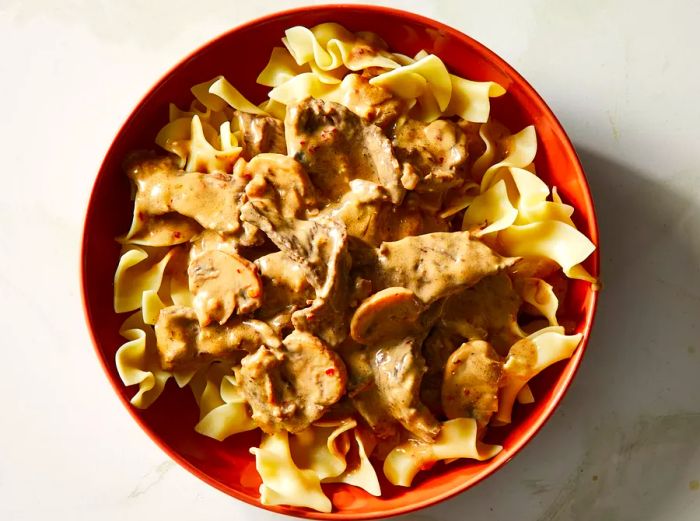 A top-down view of a large bowl filled with rich and creamy beef stroganoff.