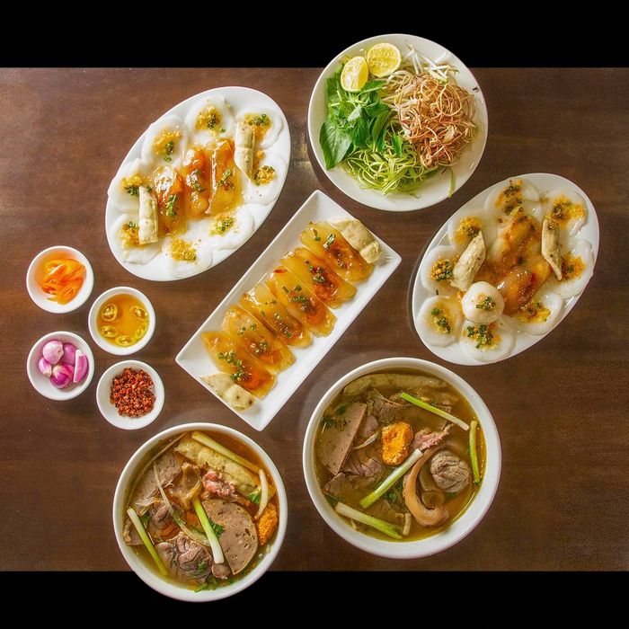 A photo of Bún Bò Gốc Huế O Tú showing a vibrant, delicious bowl of Huế-style beef noodle soup that’s beloved by many customers.