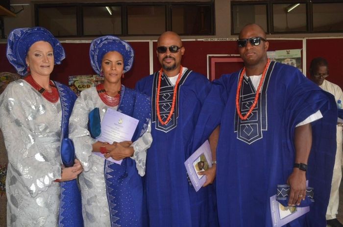 From left: Catherine (the author’s sister-in-law), the author, Femi (the author’s brother), and Mike (the author’s husband) at Archbishop Vining Church, Ikeja, Lagos, in May 2016. The funeral guests are adorned in royal blue aso oke, the ceremonial fabric of Yoruba culture, complemented by ileke, the coral necklaces traditionally worn for celebrations.