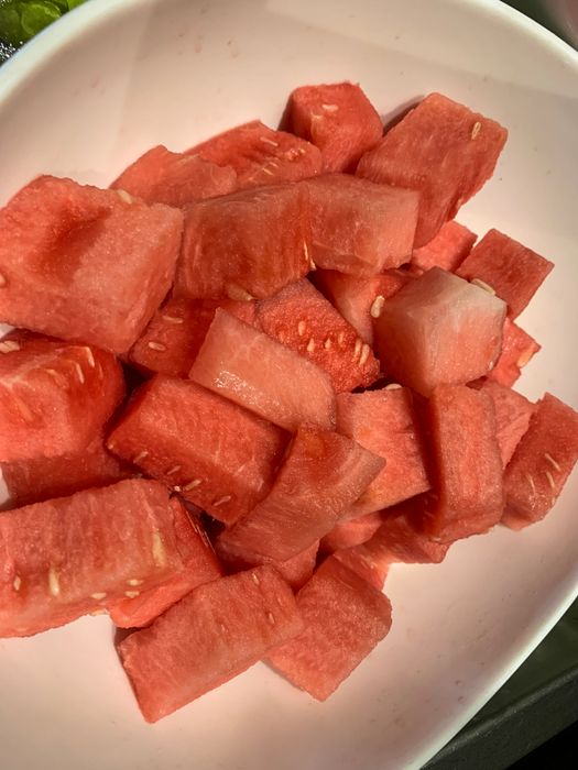 A bowl filled with cubed watermelon pieces