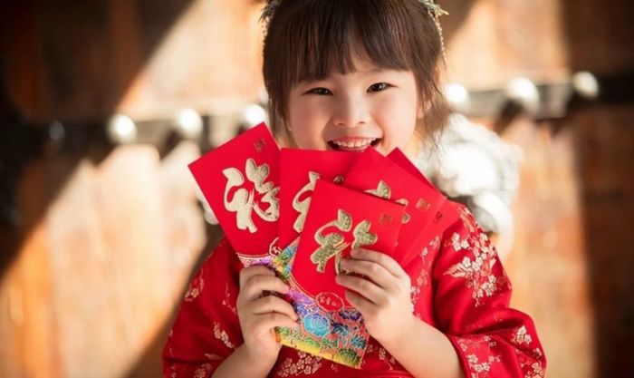 Các bé chụp hình Tết cùng những bao lì xì đỏ thắm