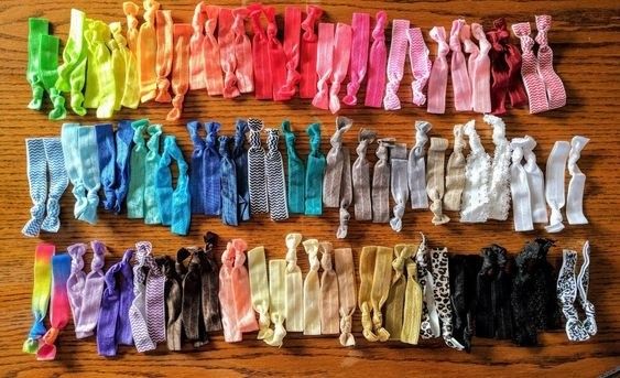 reviewer's neatly arranged collection of colorful hair ties