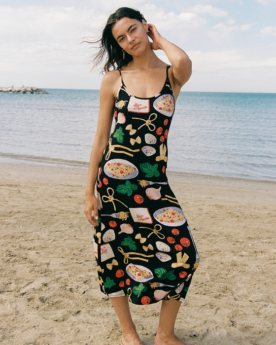 model wearing a slip dress featuring pasta-themed designs