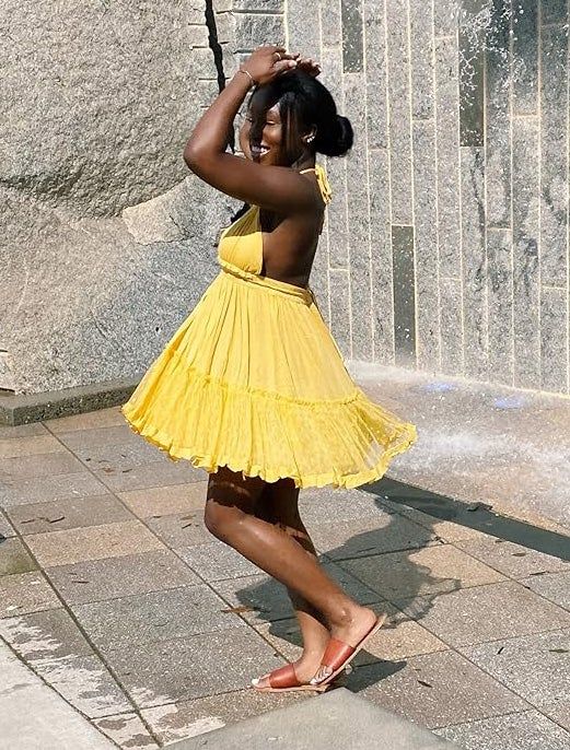 reviewer wearing a yellow dress
