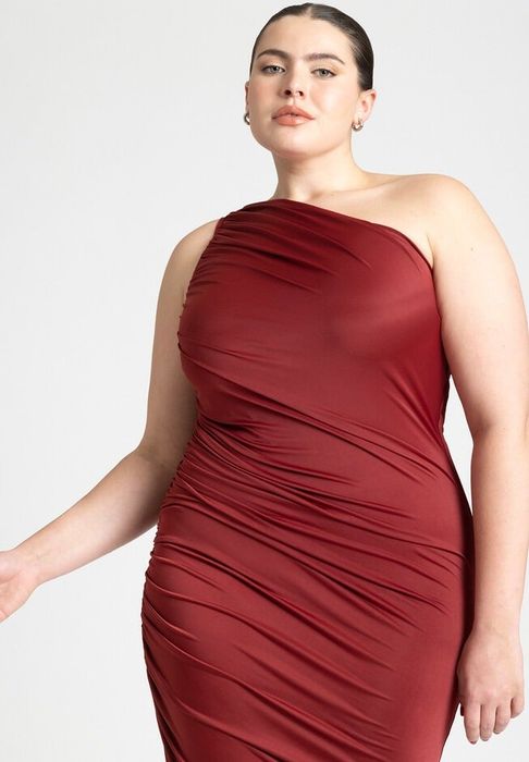 A person in a chic, fitted red one-shoulder dress exuding confidence; featured in a shopping article