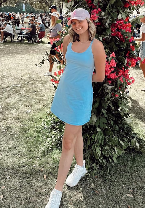 reviewer posing in a light blue tennis dress