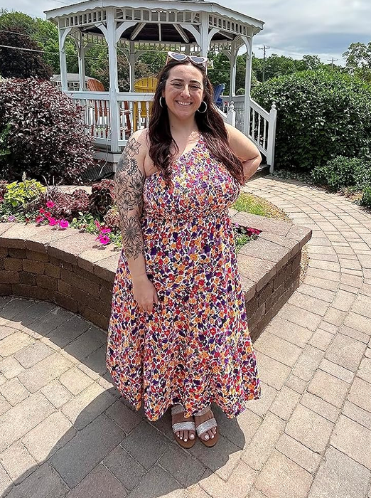 reviewer wearing a purple floral dress