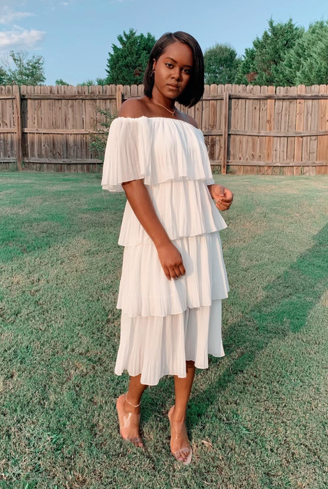 reviewer in a white tiered maxi dress