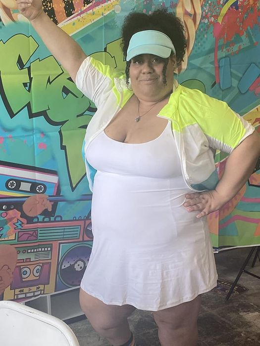 reviewer wearing a white dress