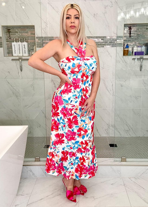 reviewer in a red and blue floral dress