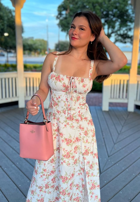 reviewer in a pink floral dress