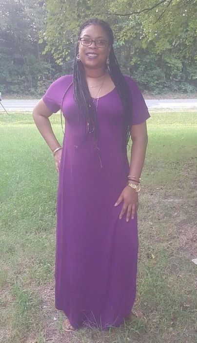 reviewer wearing the purple version of the dress