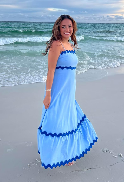 reviewer modeling a white maxi dress with blue lace details