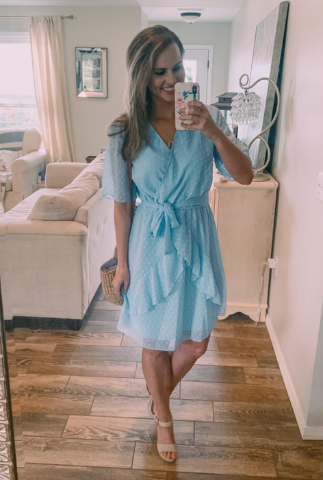 reviewer wearing the light blue above-the-knee dress