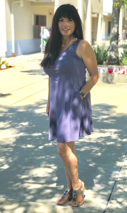 reviewer wearing the dress in a purple-gray shade